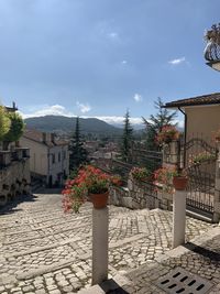 Street amidst buildings against sky