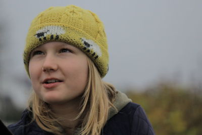 Portrait of young woman wearing hat