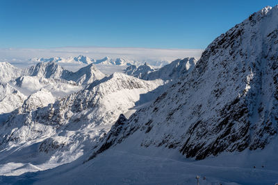 Scenic view of snowcapped alps against blue sky