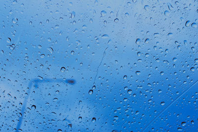 Full frame shot of wet glass window during rainy season