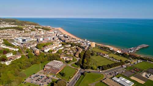 High angle view of townscape by sea against sky