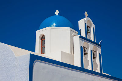 Low angle view of white building against blue sky