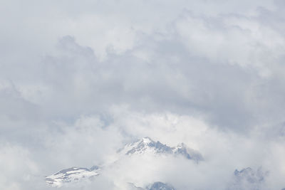 Low angle view of snowcapped mountains against sky