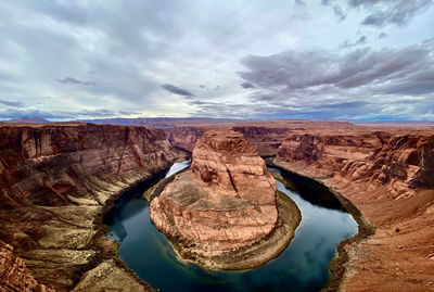 Scenic view of rock formations against cloudy sky
