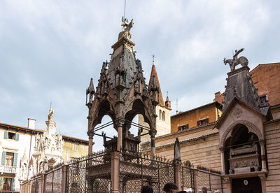 Low angle view of statue of historic building against sky