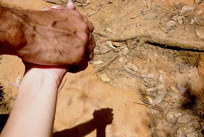 Close-up of man hand on rock