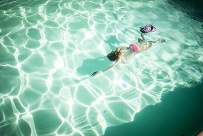 High angle view of woman swimming in pool