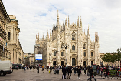 People at milan cathedral against sky