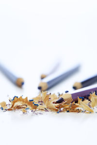 Close-up of colored pencils against white background