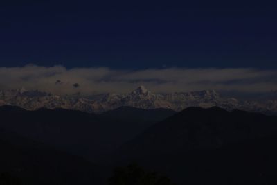 Scenic view of silhouette mountains against sky at night