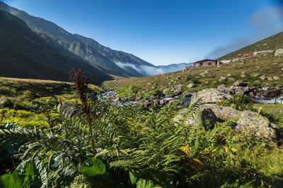 Scenic view of mountains against blue sky