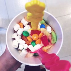 High angle view of hand holding candies