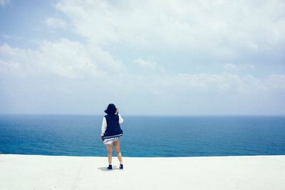 Rear view of man standing on beach