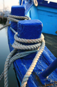 Close-up of rope tied on boat at harbor