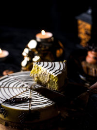 Close-up of lit candles on table