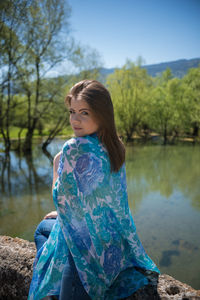 Woman sitting on retaining wall