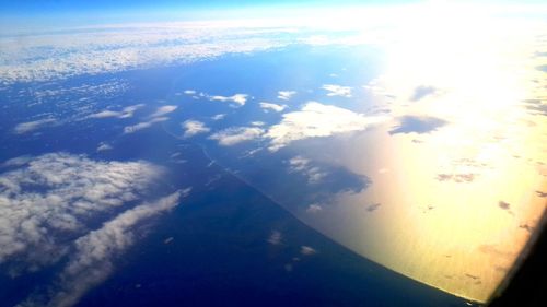 Aerial view of landscape against blue sky