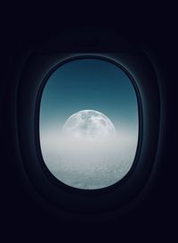 Moon seen through airplane window