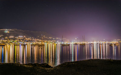 Illuminated city at waterfront