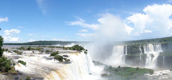 Scenic view of waterfall against sky