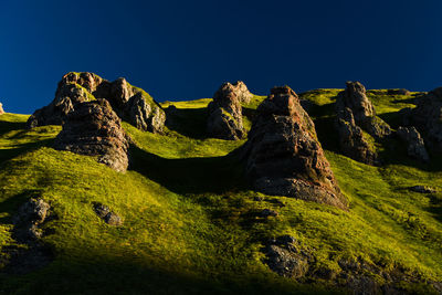 Rock formations on mountain against clear sky