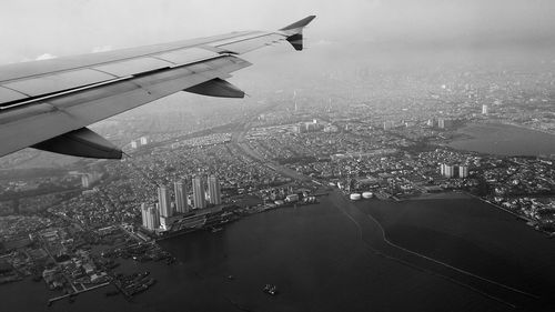 Aerial view of cityscape seen through airplane window