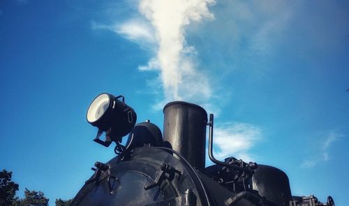 Low angle view of smoke stack against sky