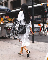 Full length of woman standing by railing