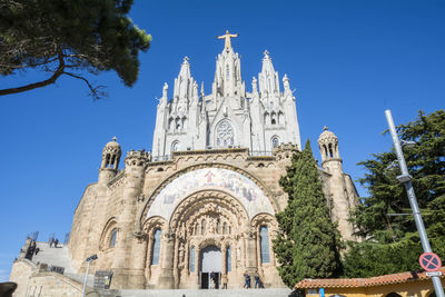 Low angle view of historic building against clear blue sky