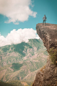 Man standing on mountain against sky