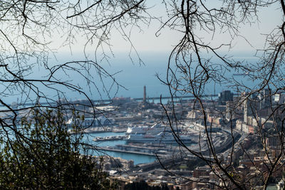 Scenic view of sea by city against sky