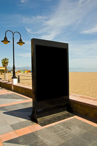 Street by sea against sky