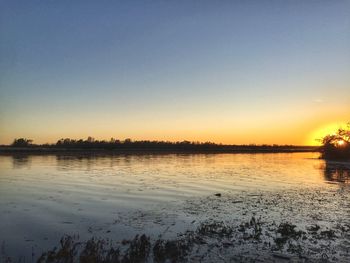 Scenic view of lake against clear sky during winter