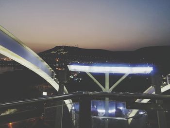 View of bridge over river at night