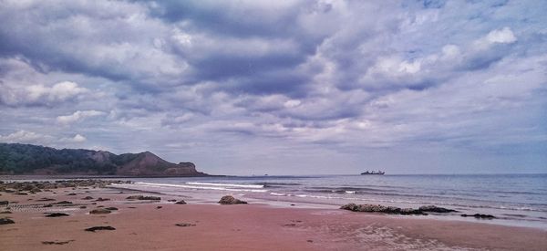 Scenic view of sea against cloudy sky