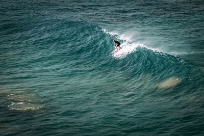 High angle view of man surfing in sea