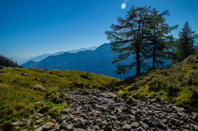 Scenic view of mountains against blue sky