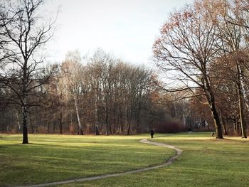 Man on golf course against sky