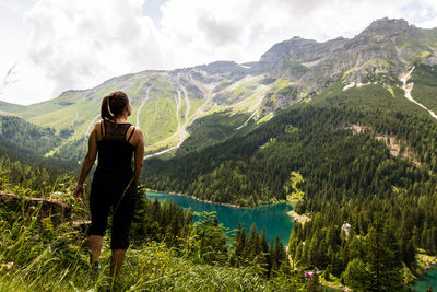 Rear view of woman hiking on mountain by obernberger see lake