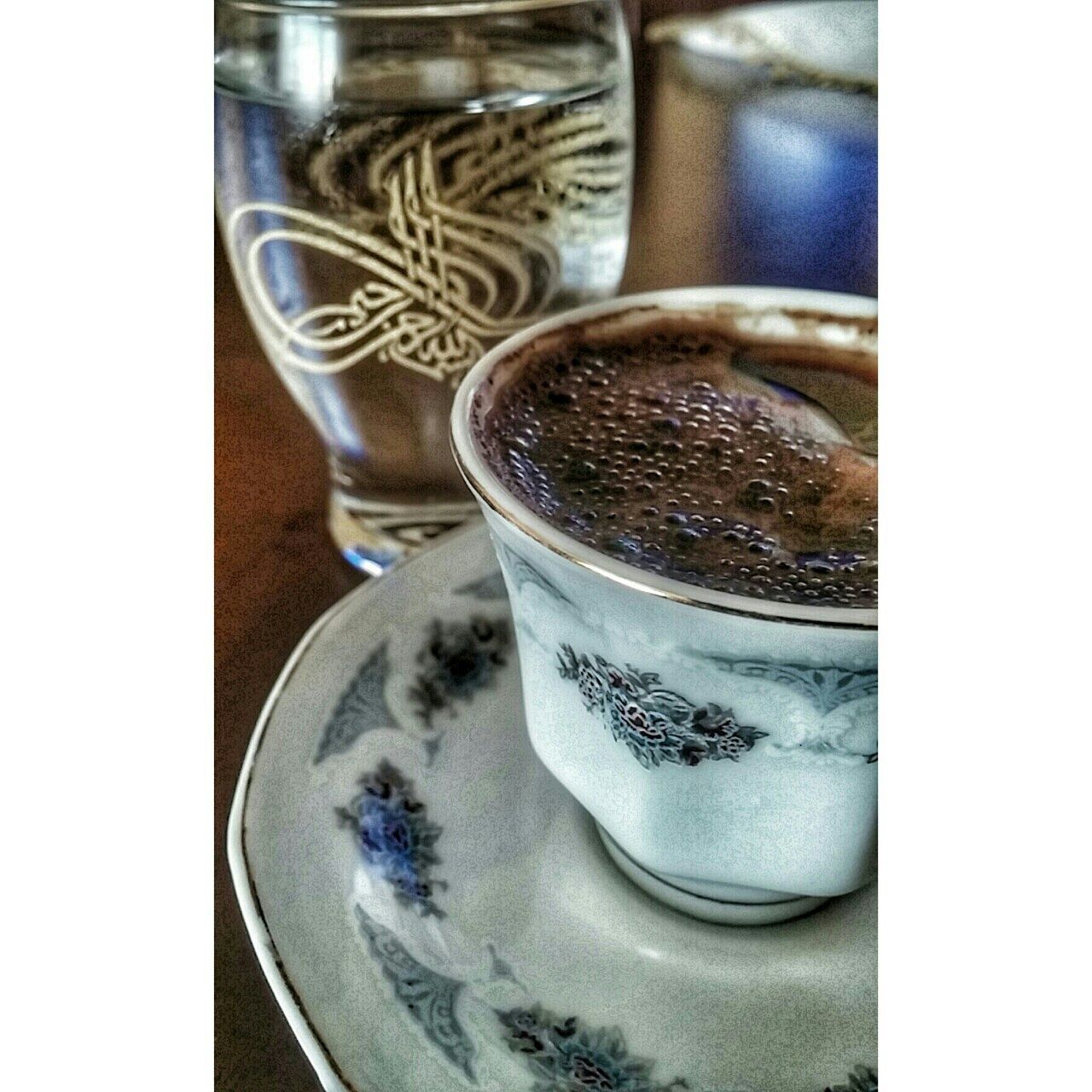 transfer print, auto post production filter, indoors, close-up, glass - material, still life, drink, drinking glass, table, refreshment, transparent, food and drink, glass, focus on foreground, no people, spoon, reflection, container, water, single object