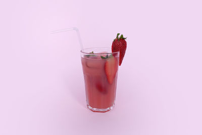 Close-up of drink in glass against white background