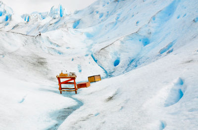 Wooden table and boxes on glacier