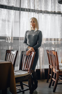 Full length of woman sitting on table