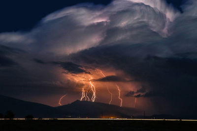 Scenic view of lightning against sky at night