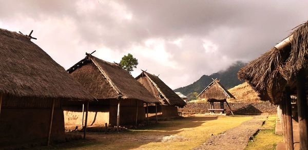 Panoramic view of village and houses against sky