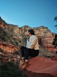 Portrait of man standing on mountain against clear sky