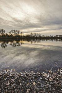 Scenic view of lake against sky during winter