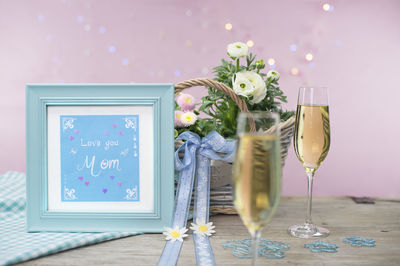 Love letter for mother. spring flowers, champagne and chocolate are gifts. 