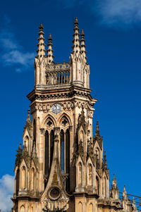 Low angle view of historical building against blue sky