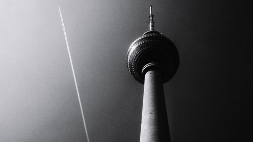 Low angle view of communications tower against sky